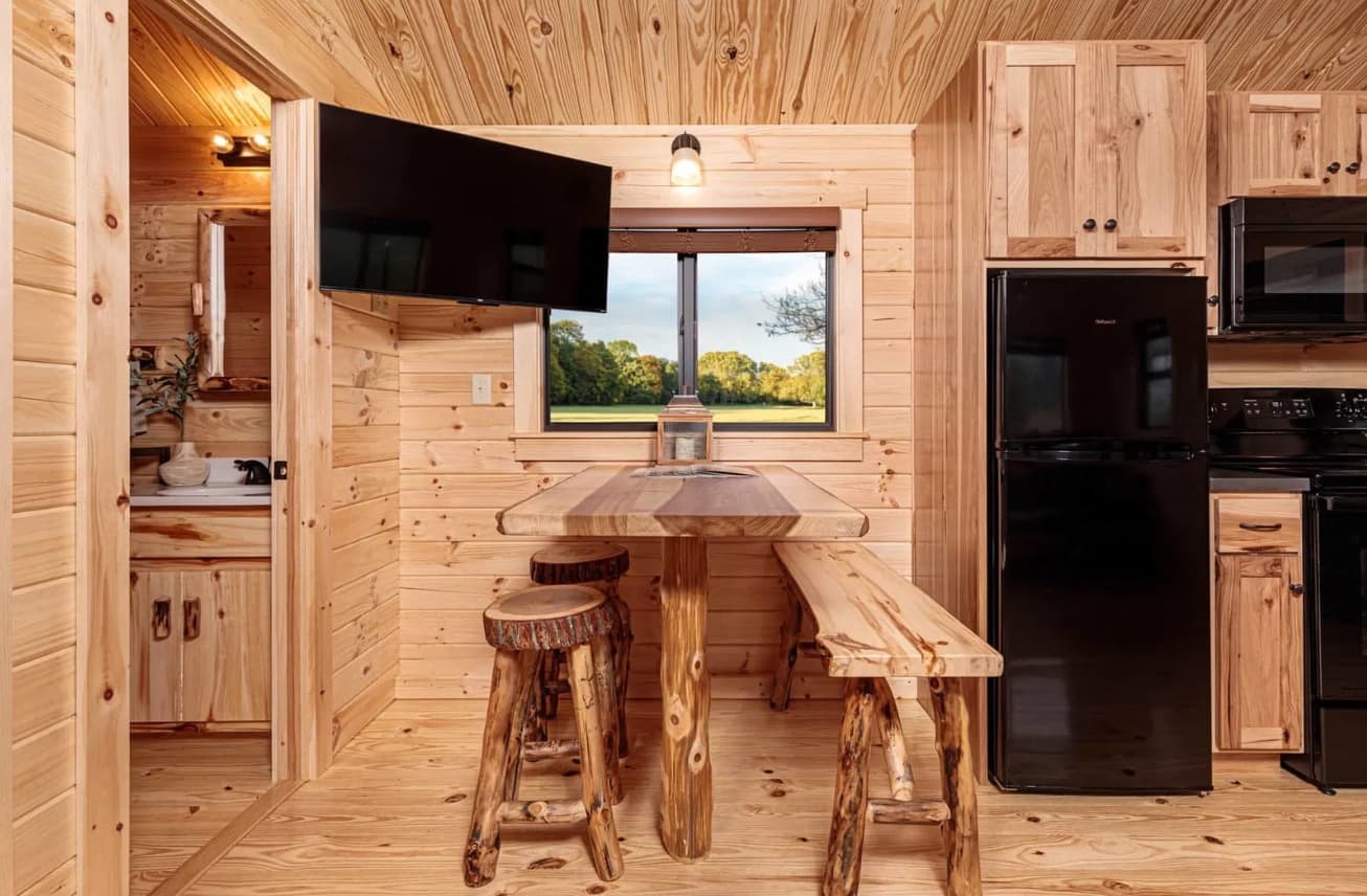 Cabin bar counter with rustic log stools and window view